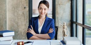 Attorney sitting at her desk - Attorney sitting at her desk - Above The Bar - Attorney sitting at her desk - Above The Bar